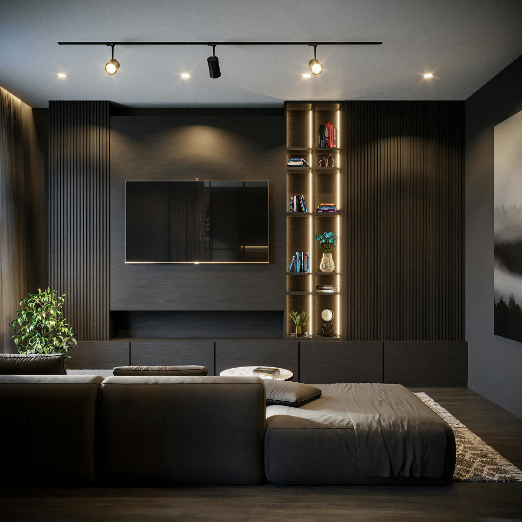 Modern dark living room with a wall-mounted TV, black media wall, and a tall, lit bookcase filled with books and decor above low storage cabinets.
