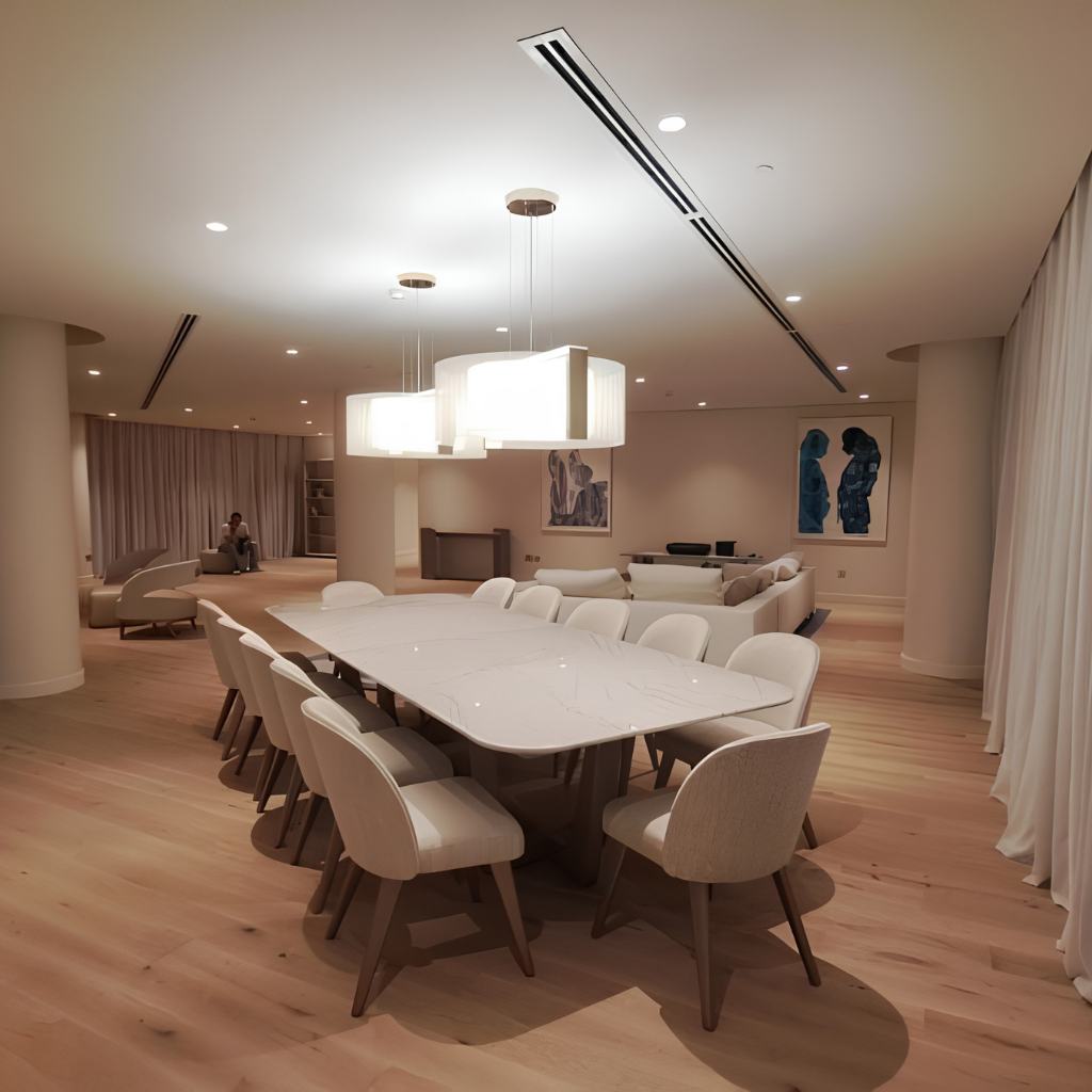 Modern banquet-style dining room with a long white marble table and cream chairs under large pendant lights.